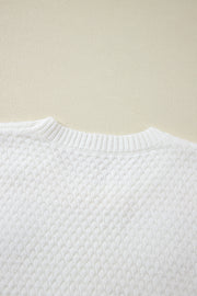 White knit sweater with textured diamond pattern and ribbed crew neck.