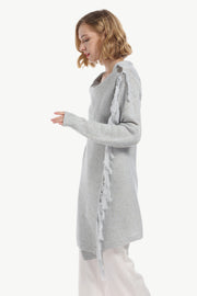 Gray asymmetric fringe knit cardigan with a button detail on the shoulder.