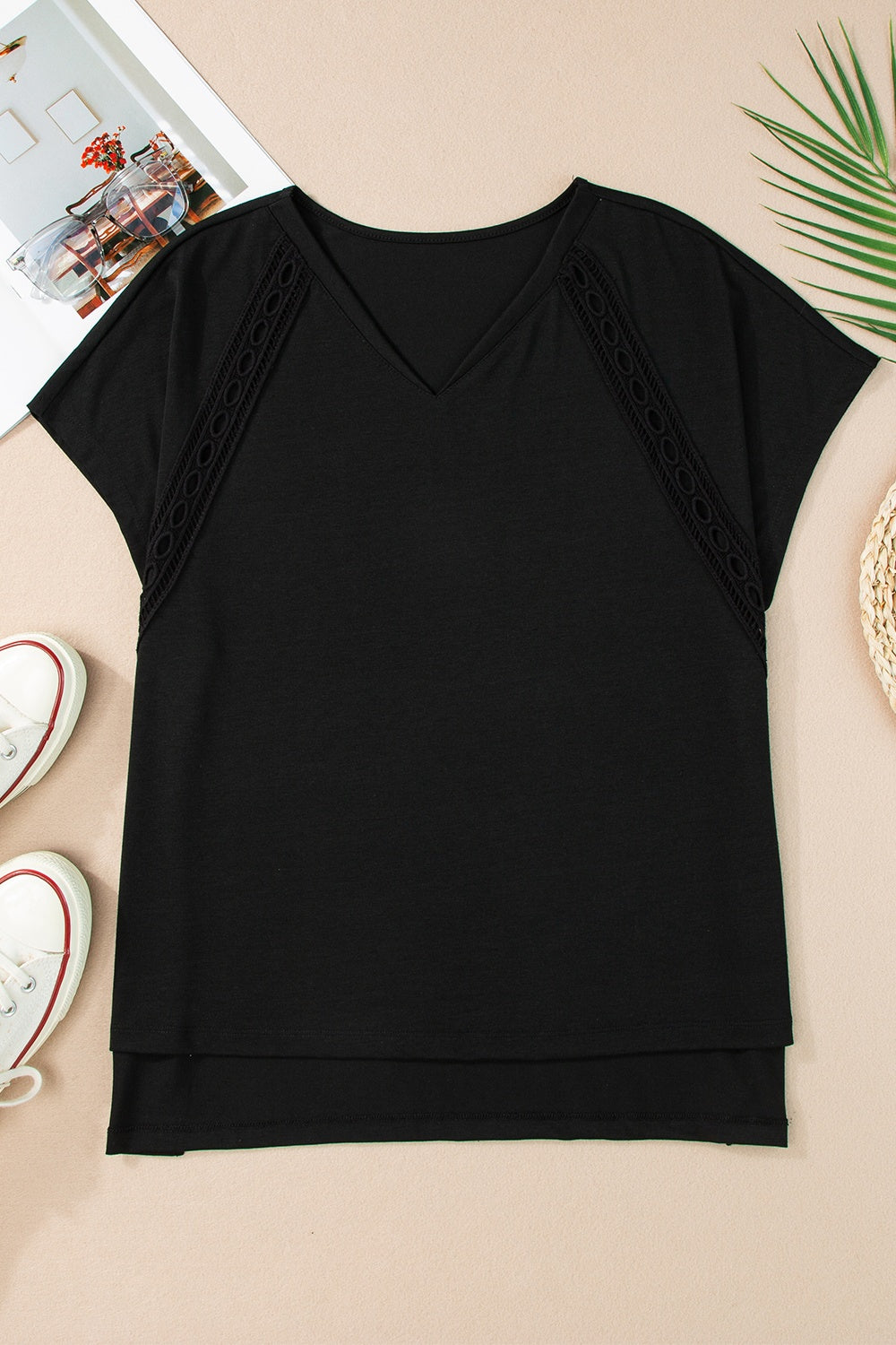 Black dolman sleeve blouse with perforated trim and V-neck