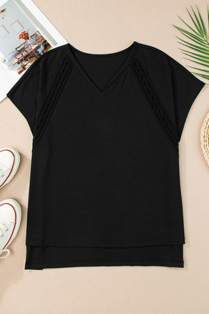 Black dolman sleeve blouse with perforated trim and V-neck
