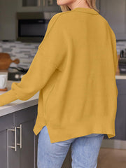 Ribbed-knit relaxed fit sweater in Mustard with crewneck and side slits.