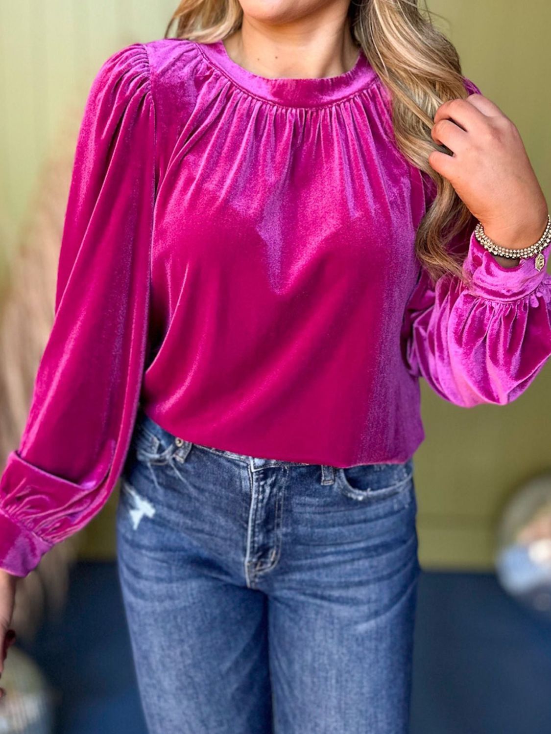 Hot pink velvet blouse with ruched neckline, puff sleeves, and ruffled cuffs.