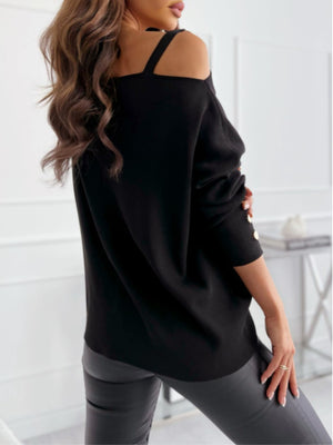 Black off-shoulder knit top with buckle detail on sleeve