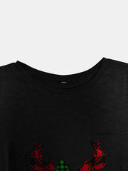 Black tee with asymmetrical button detail and plaid reindeer graphic.