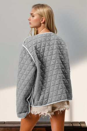 Gray diamond quilted jacket with white piping and a bow closure detail.