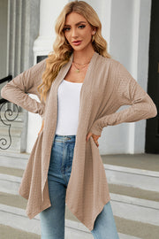 Tan textured knit cardigan with asymmetrical drape front and long sleeves.