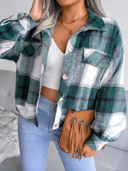 Oversized green tartan shacket with patch pockets and button front, worn open over a white crop top.