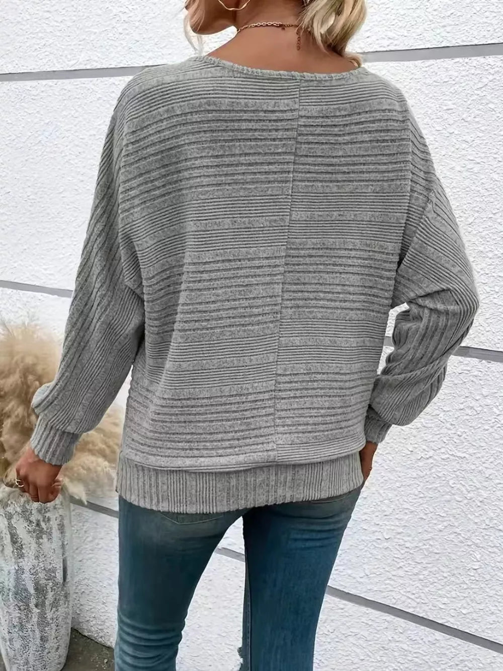 Gray ribbed acrylic sweatshirt with dolman sleeves and crew neck, shown from the back.