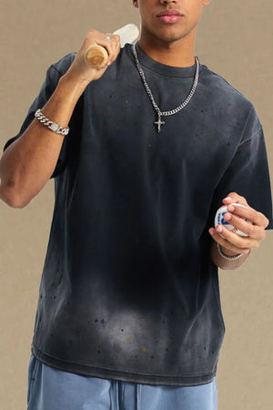 Oversized black t-shirt with paint splatter detail and crew neck.