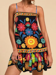Black mini dress with vibrant floral print, square neckline, and spaghetti straps.