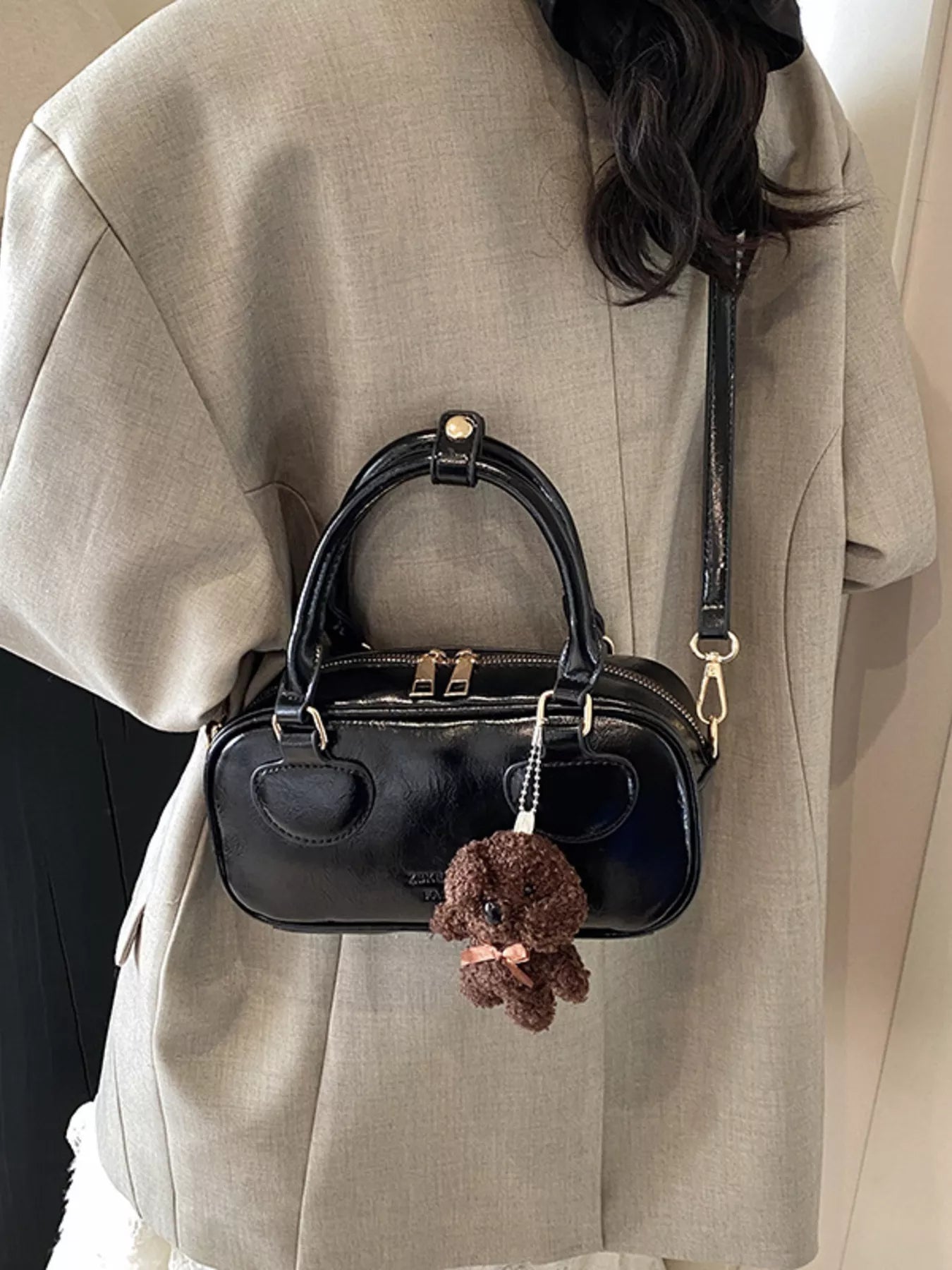 Black mini PU leather crossbody bag with top handles and a teddy bear charm