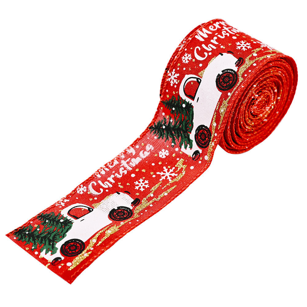 Red ribbon with white trucks, Christmas trees, and snowflakes, and gold glitter accents.