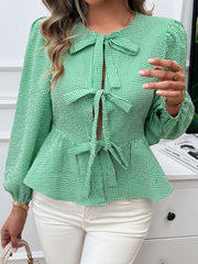 Green gingham peplum blouse with tie bow details and puff sleeves
