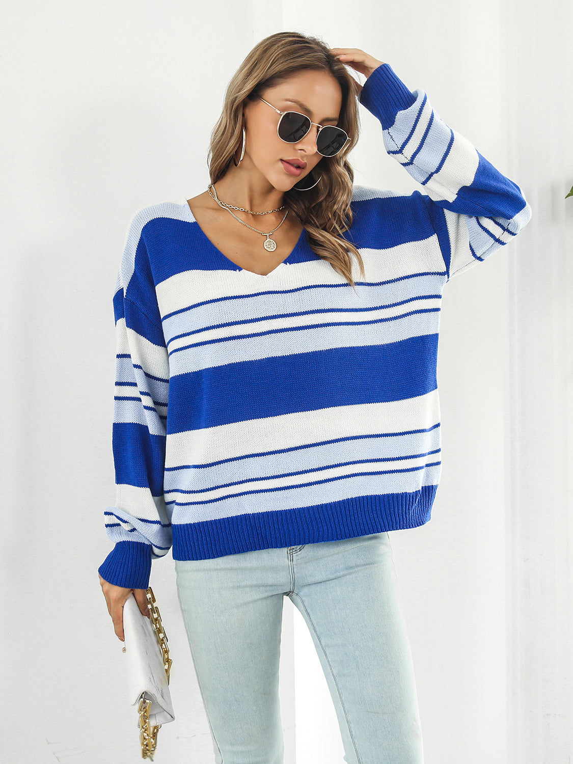 Blue and white striped V-neck acrylic sweater with a relaxed fit.