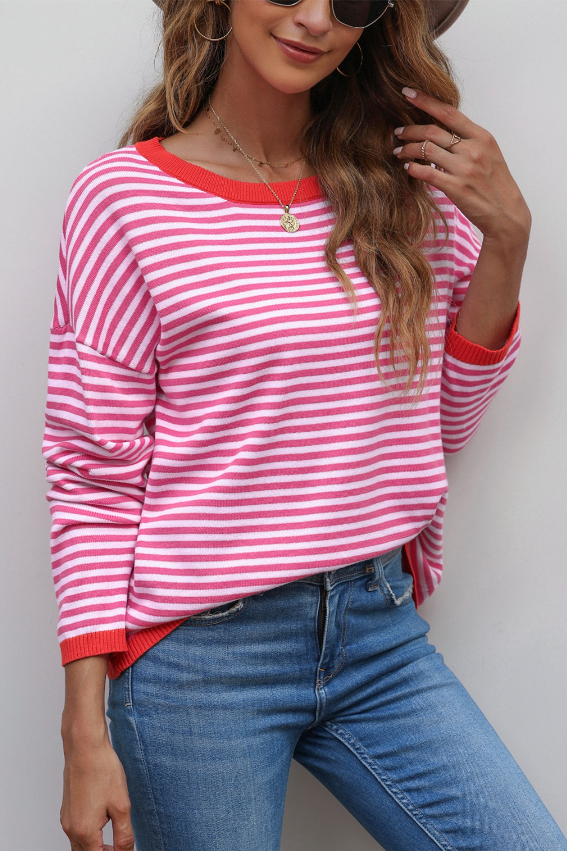Striped crewneck sweater with contrast red trim and crew neckline.