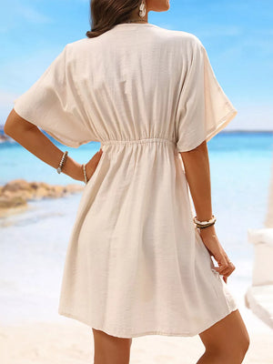 Tan V-neck cover-up dress with elastic waist and short sleeves.