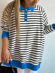 Polo collar long-sleeve sweatshirt with stripe pattern, blue collar and cuffs, and buttoned placket.