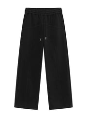 Black cotton sweatpants with drawstring waist and wide legs.