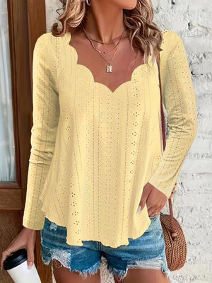Light yellow scalloped eyelet yoke blouse with long sleeves and a V-neckline.