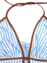 Blue and white striped cotton halter maxi dress with smocked bodice and brown trim.