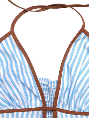 Blue and white striped cotton halter maxi dress with smocked bodice and brown trim.