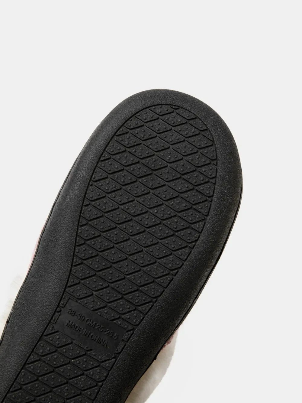 Cable knit house slippers with shearling lining and textured sole.