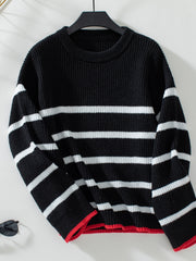 Black ribbed knit sweater with white stripes and red trim detail.