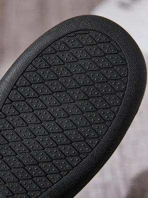 Black suede moccasin slide sole with diamond tread pattern for grip.