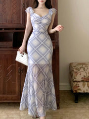 Blue ruched plaid bodycon maxi dress with ruffled cap sleeves and sweetheart neckline.