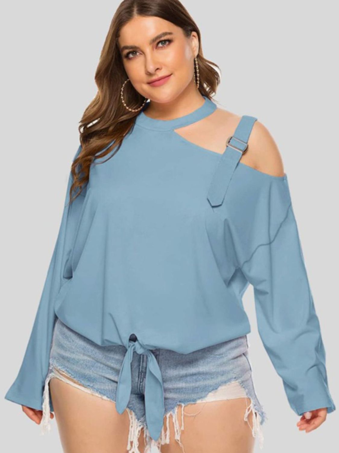 Light blue blouse with shoulder cutout, buckle detail, and tie front.