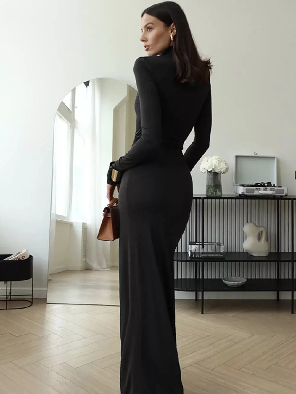Black turtleneck maxi dress with tie detail and long sleeves, shown from the back.