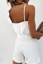 White camisole with asymmetric ruffle strap detail and thin spaghetti straps.