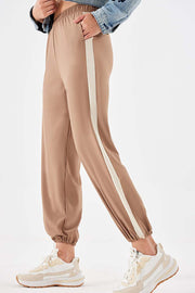 Camel relaxed trousers with a cream side stripe and elasticated cuffs.