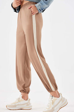 Camel relaxed trousers with a cream side stripe and elasticated cuffs.