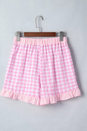 Pink gingham cotton shorts with ruffle hem and drawstring waist.