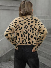 Fuzzy knit cropped sweater with leopard print, long sleeves, and crew neck.