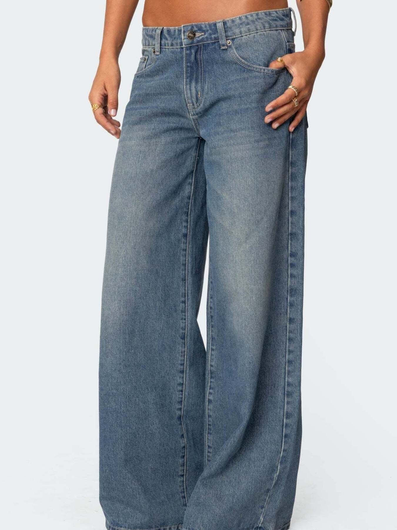 Dark blue wide leg denim jeans with button fly and classic five pocket styling.