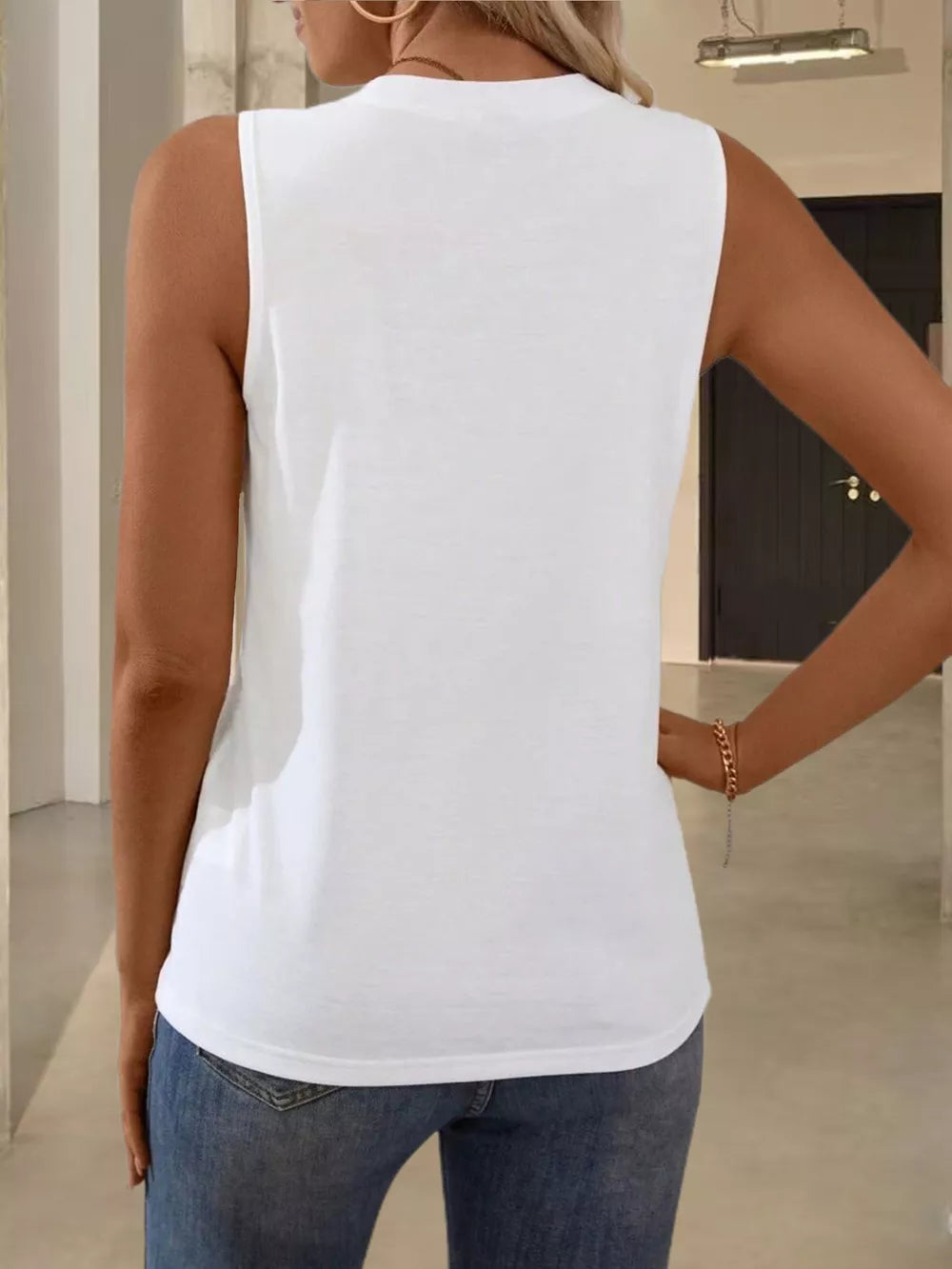 White sleeveless tank top with textured pleats, crew neck, and a casual fit.