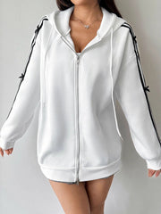 White zip-up hoodie with black stripe and bow details on sleeves.