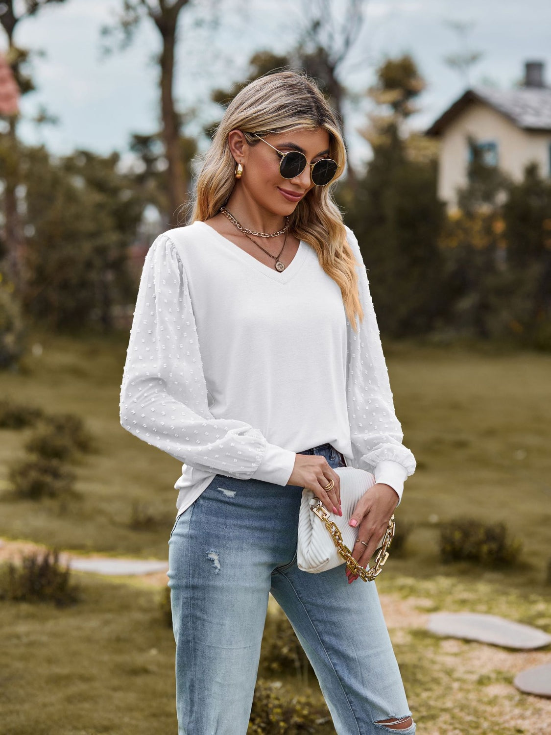 White Swiss dot sleeve v-neck blouse with a casual fit.