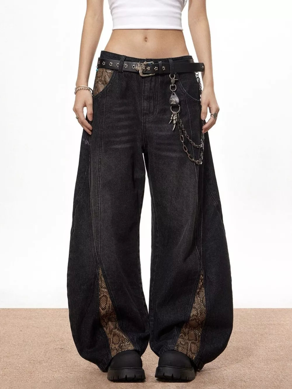 Black wide leg jeans with snake print accents and chain belt detail