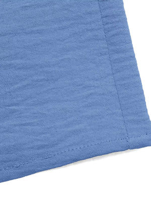 Blue textured wide-leg romper detail with visible stitching.