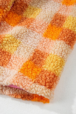 Checkerboard sherpa jacket in tangerine with a fuzzy texture and contrast collar detail.