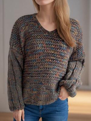 Textured knit sweater with balloon sleeves and V-neck in a multicolor flecked pattern.