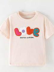 Toddler t-shirt in light pink cotton with colorful applique "love" graphic and text.