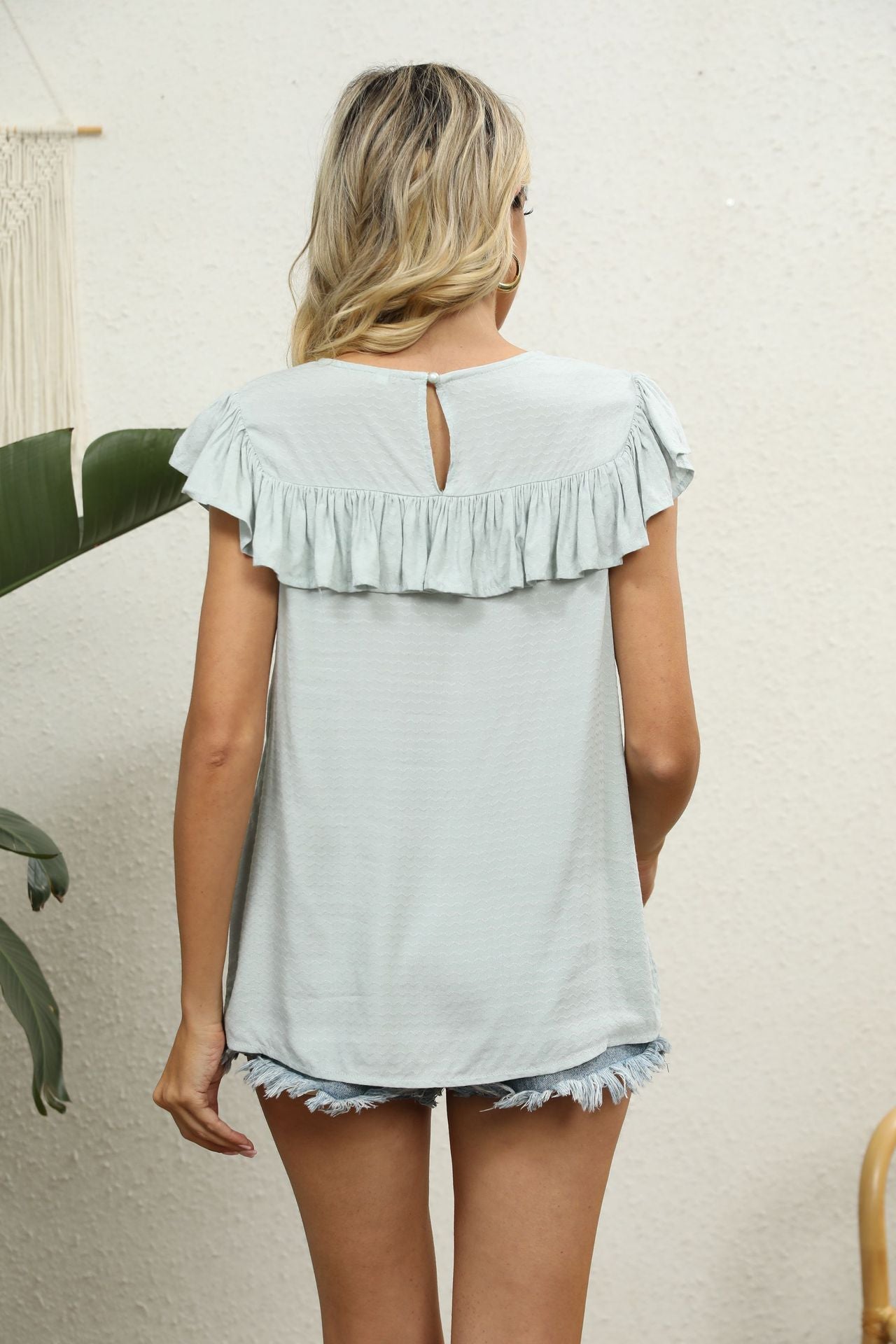 Sage green ruffle sleeve blouse with lace yoke detail and keyhole back.