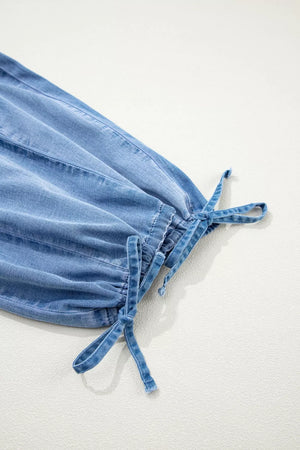 Light wash denim maternity jeans with cinched ankle and drawstring detail