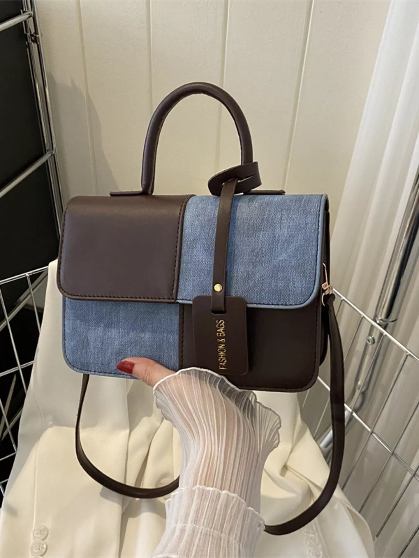 Chic two-tone PU leather handbag with denim accents and a brown top handle.