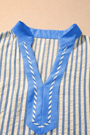 Vibrant stripe V-neck shirt with blue color block detail and decorative stitching.