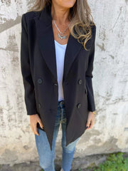 Black double-breasted blazer with sculpted lapels and button detail.